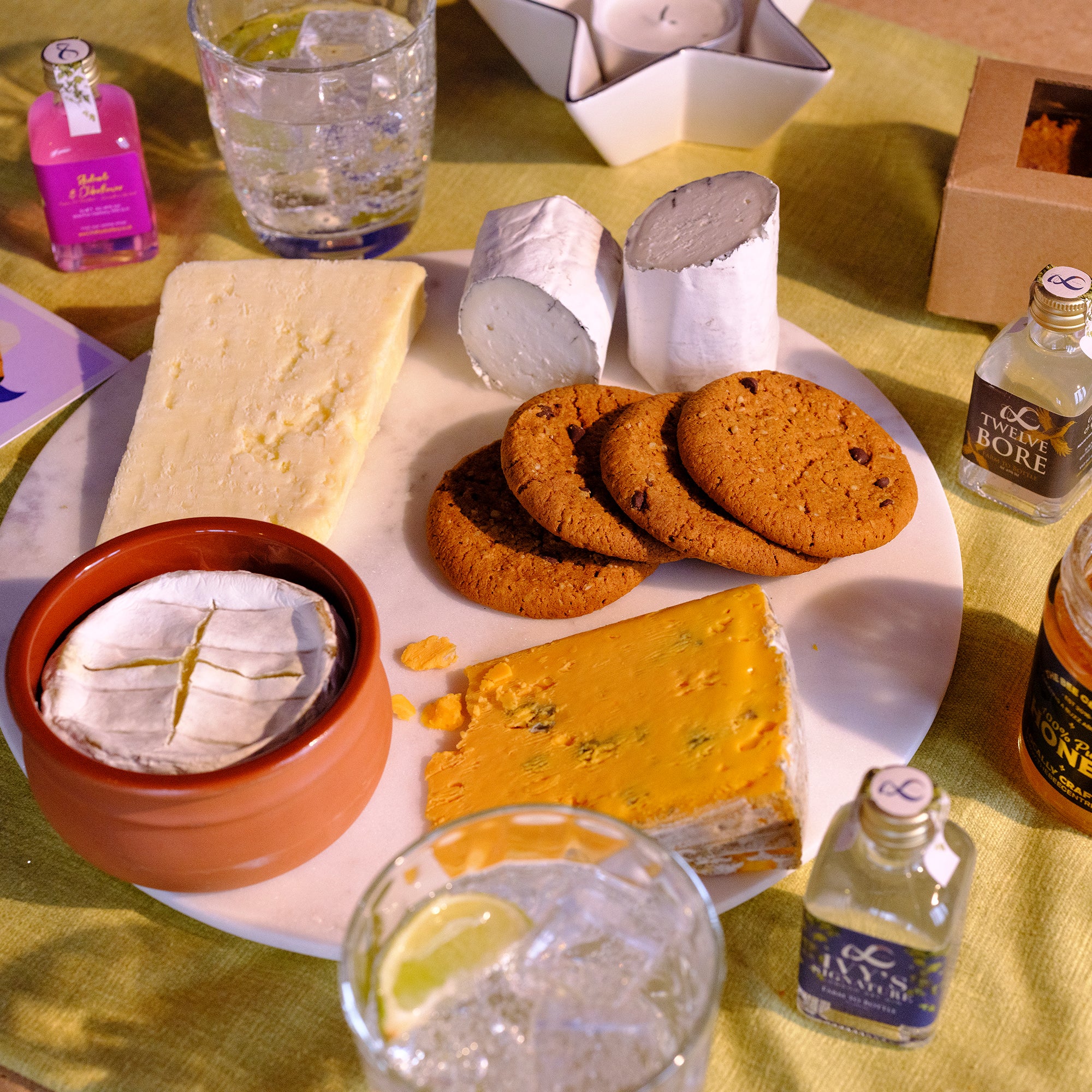 Serving suggestion for our Mother's Day Cheese Hamper | Cheeseboard with ginger parkin biscuits and a gin and tonic.