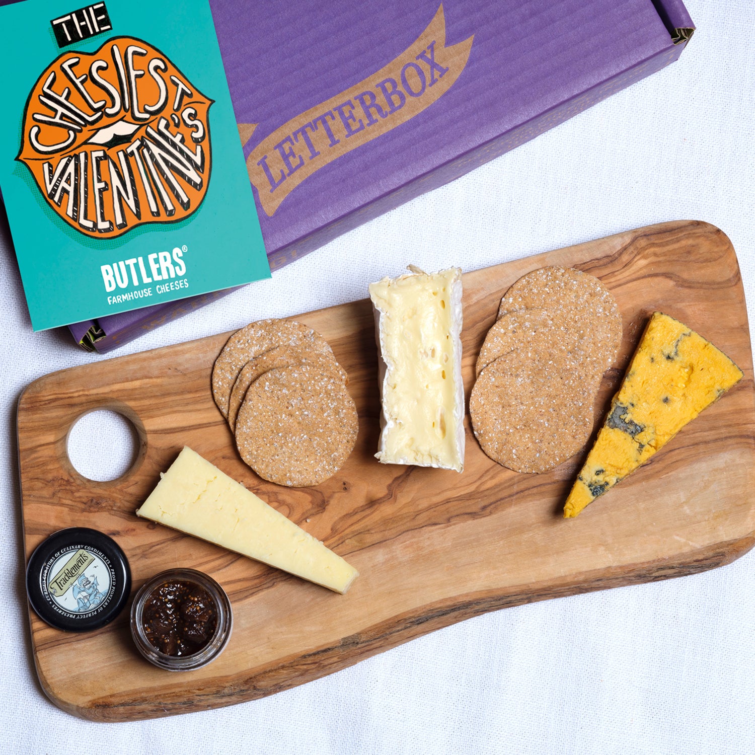 Overhead shot of the Perfect British Valentine's Cheeseboard with Crackers & Chutney on a cheeseboard