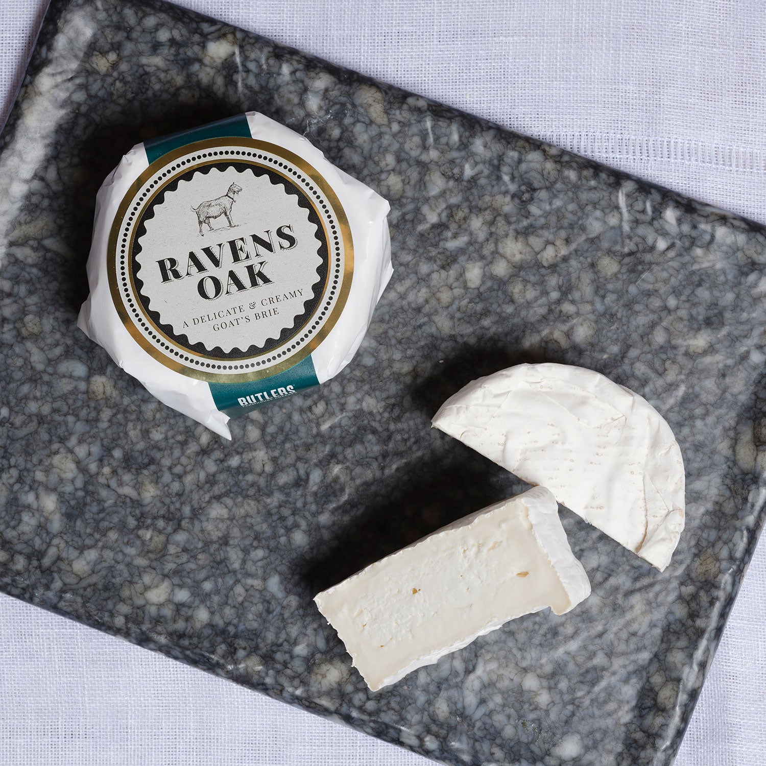 Ravens Oak Goat's Cheese on it's packaging and also sliced to its white soft centre.