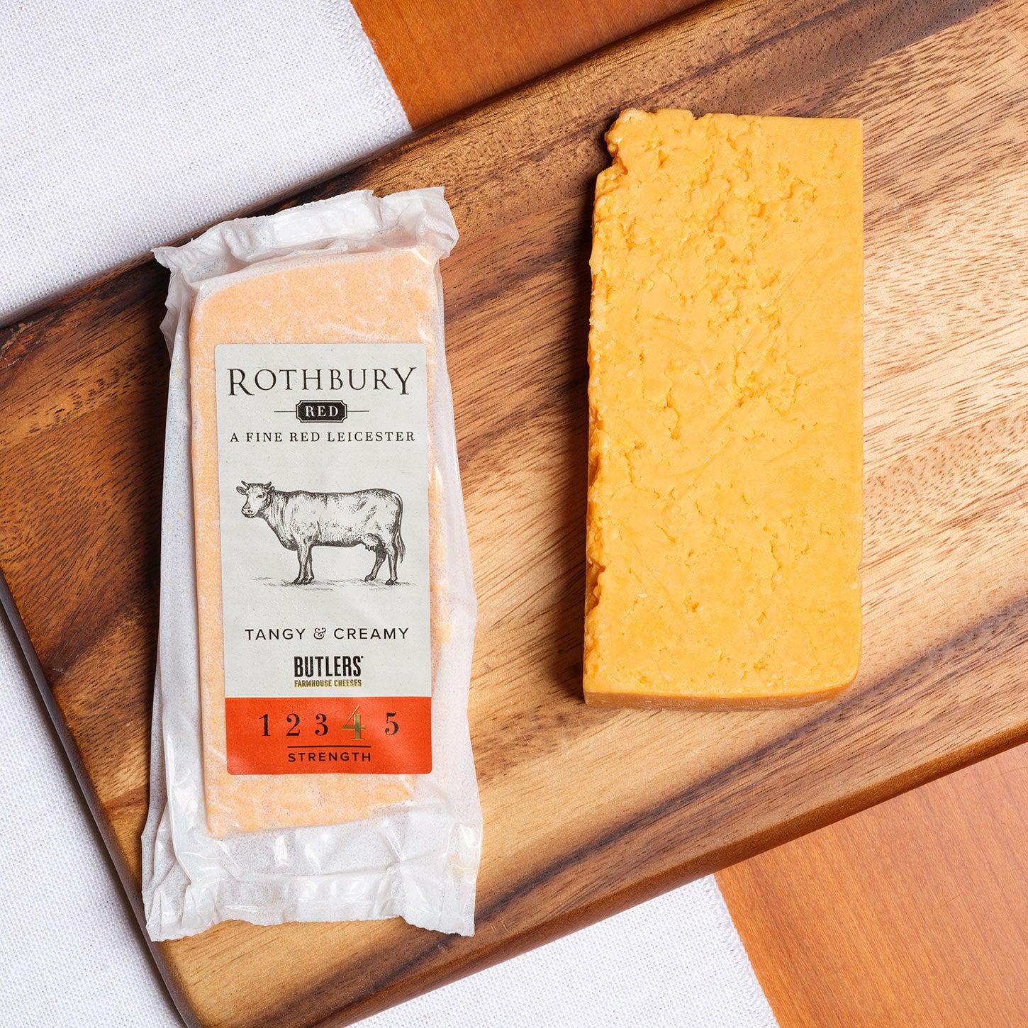 Rothbury Red is an authentic Red Leicester cheese, seen here in it's packaging and as a cheese wedge on a wooden board, Available from the Butler's Cheese Store.