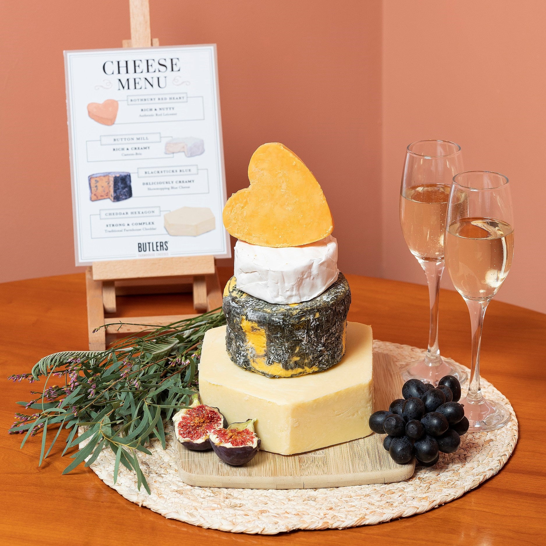 Small cheese wedding cake. Artisan cheese tower of hard, blue and soft cheese, topped with a red Lecister heart shaped cheese. Complete with our illustrated cheese menu and easel