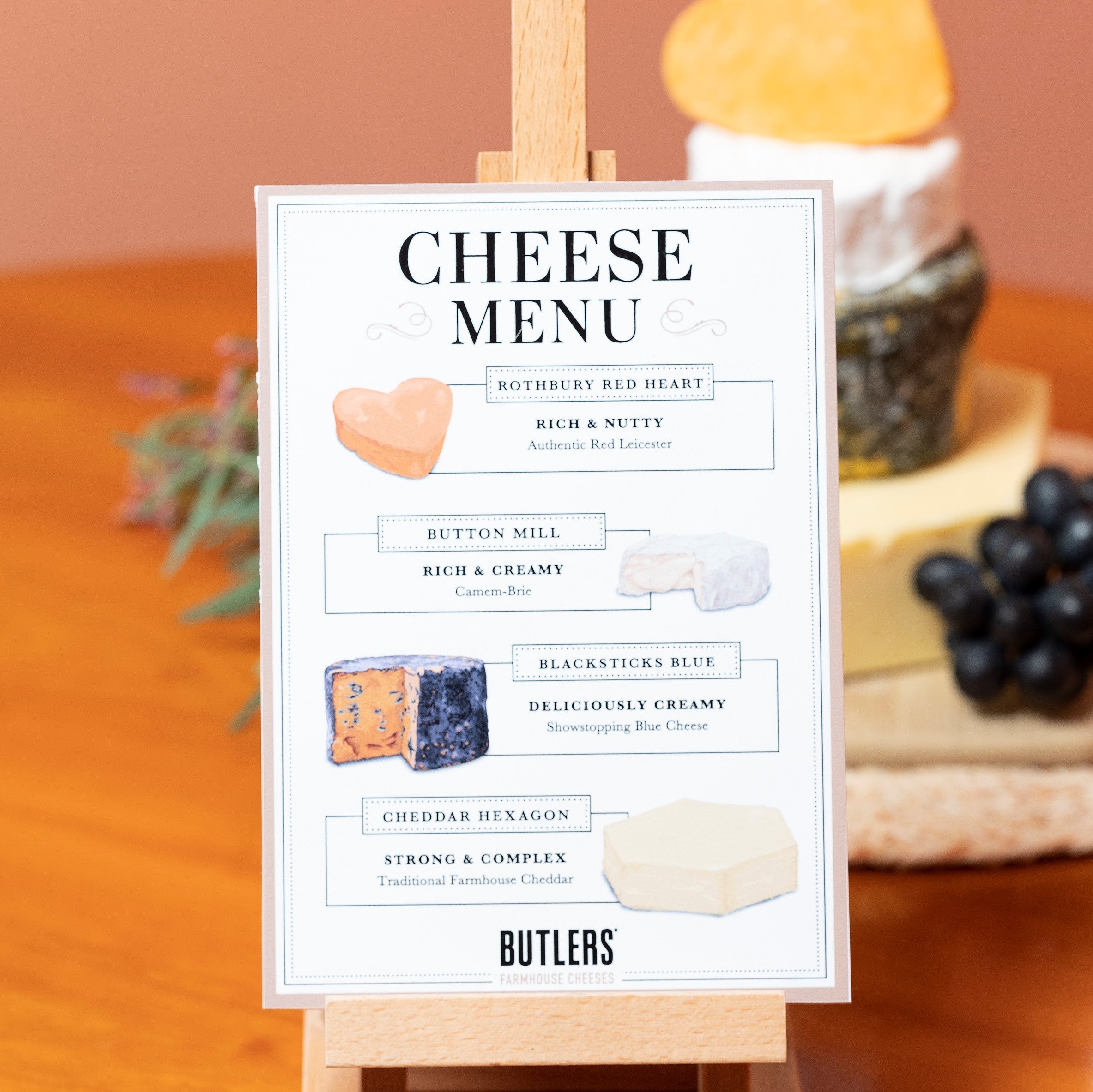 Illustrated cheese menu for our small cheese wedding cake on a wooden easel.