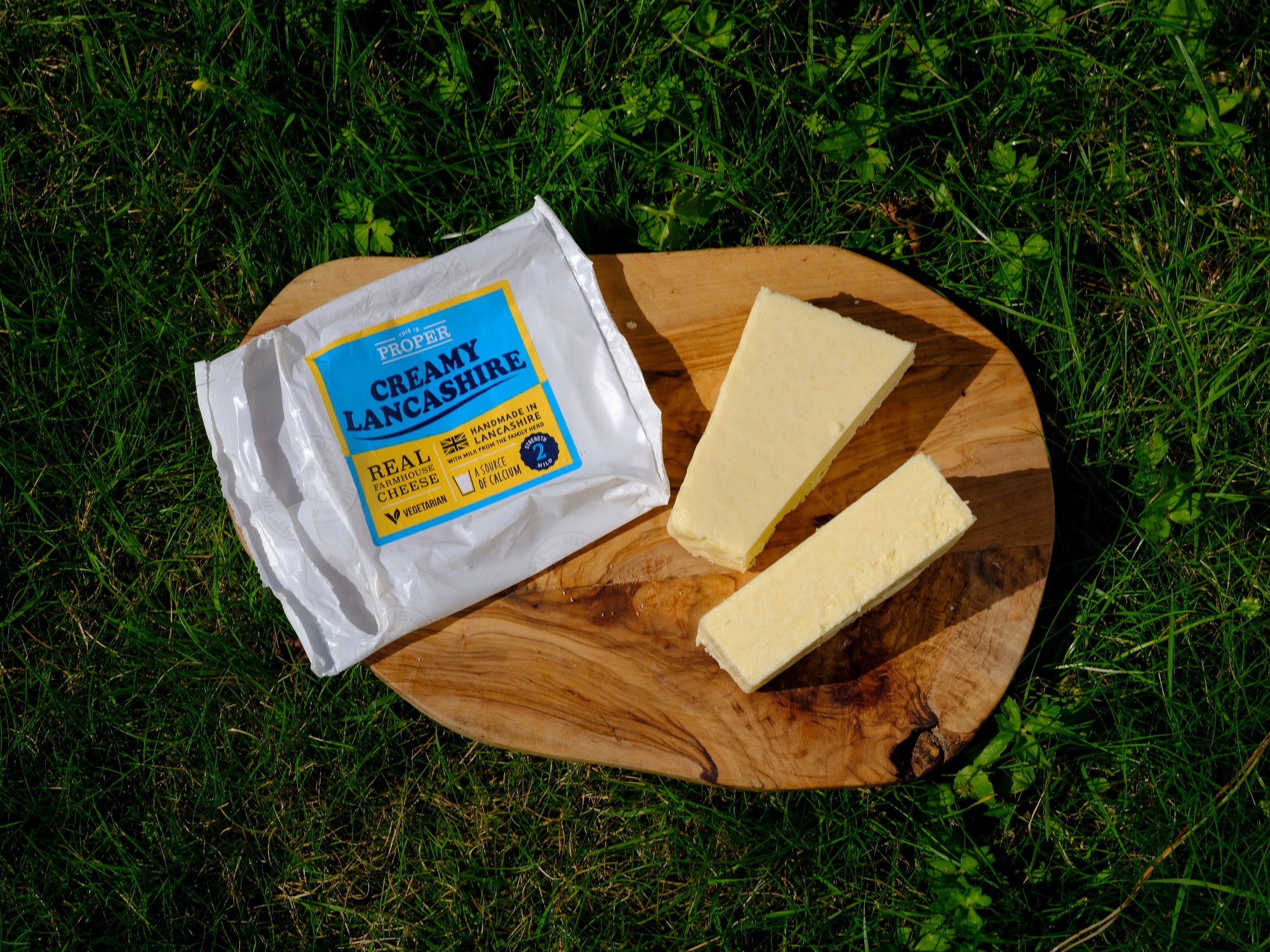 This is Proper Creamy Lancashire cheese, taken from it's packet and sliced on a wooden cheeseboard.